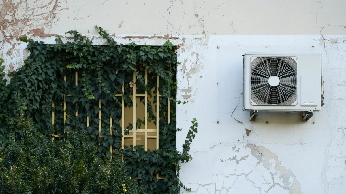 Fujitsu mini split error codes guide: outdoor mini split unit on a weathered wall next to an ivy-covered window